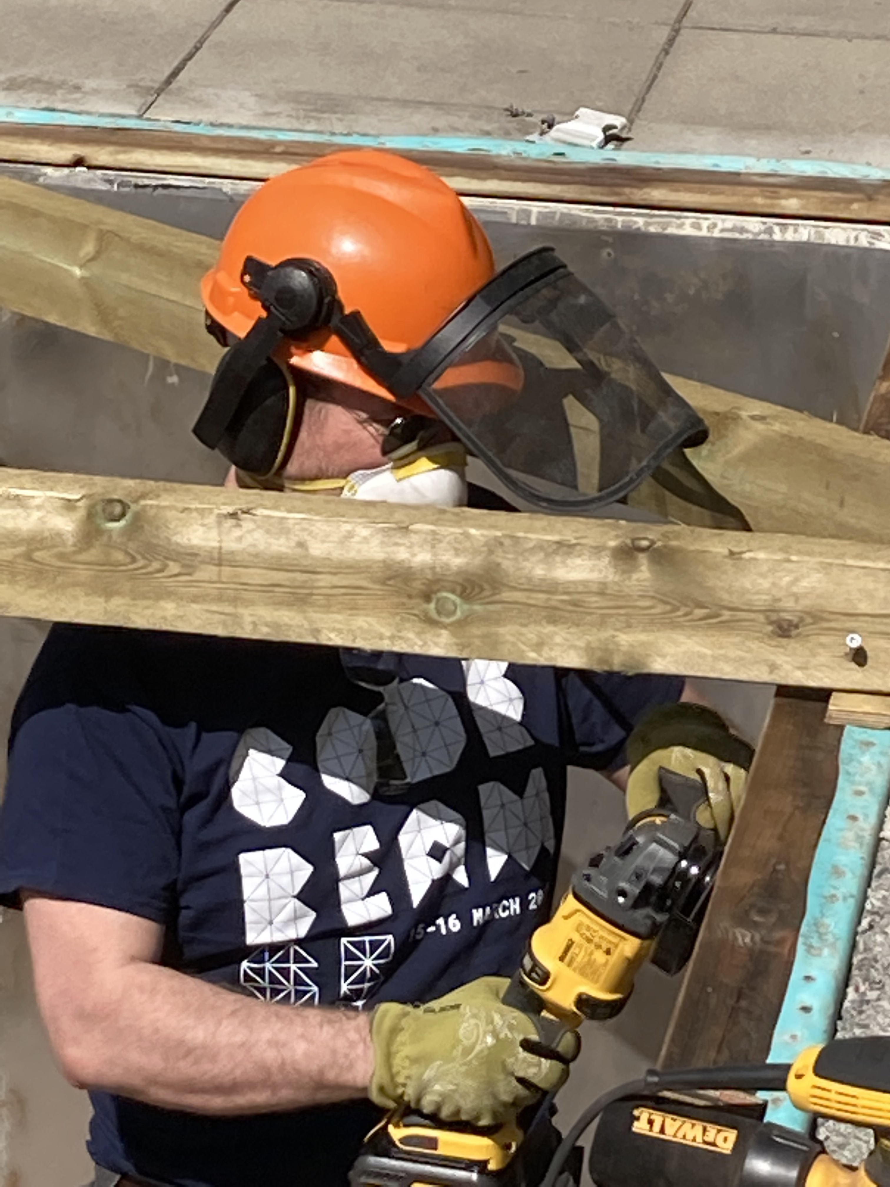 Happi with
a hardhat working with power tools.